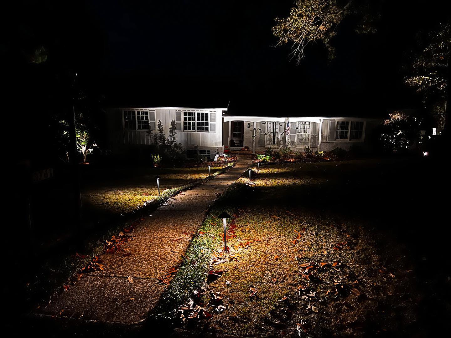 Landscape lighting illuminating a home at night
